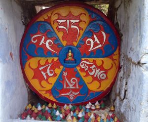 painted tibetan image in rock niche