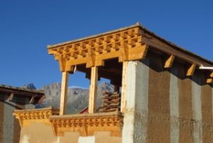 view of mountain beyond carved building roof