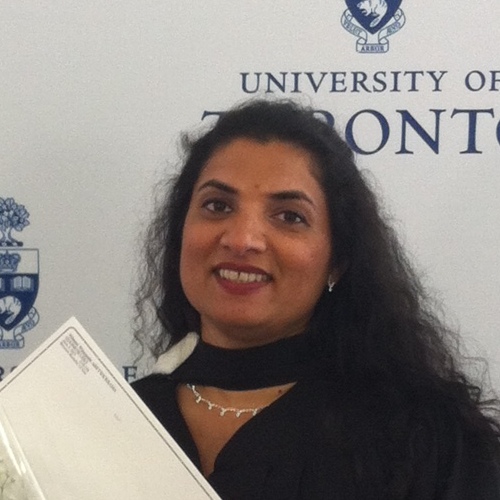 portrait of dark haired woman smiling with diploma