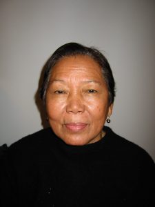 portait of gray haired woman in black sweater