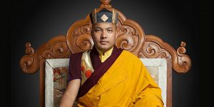 Karmapa sitting on wooden throne