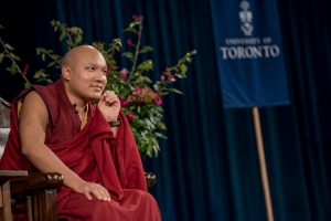 His Holiness the 17th Karmapa seated on stage