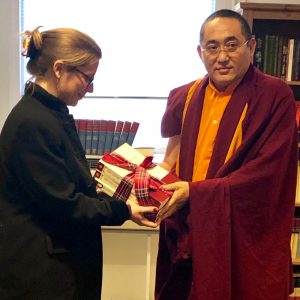 Kathog Trungpa Rinpoche hands newly published books to our centre director, Sarah Richardson