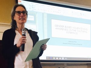 woman with glasses giving presentation
