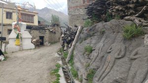 carved stone amid mountain village