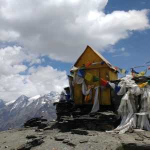 sacred site atop mountain covered in prayer flags and scarves