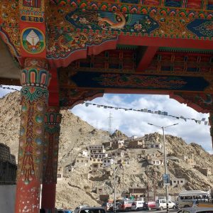 view of mountain village from under ornate gateway