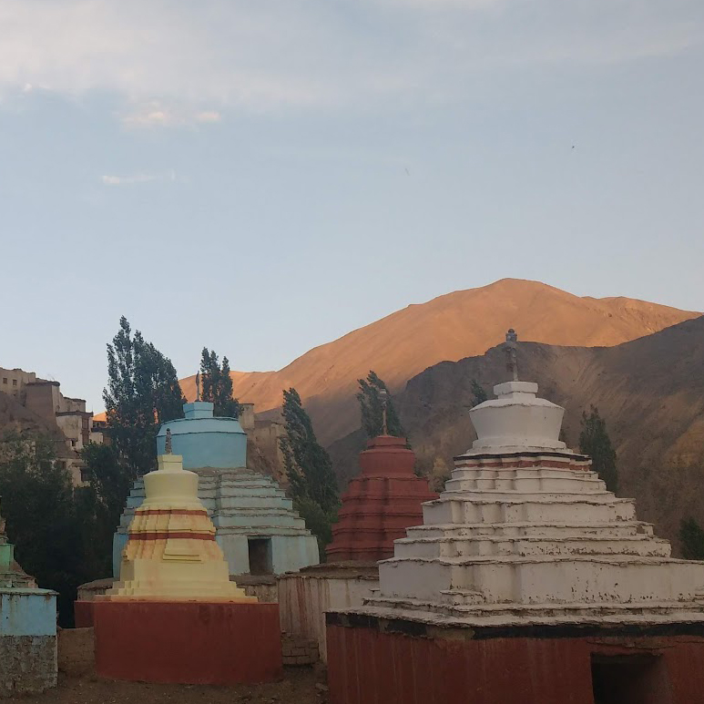 stupas with mountain range in the distance