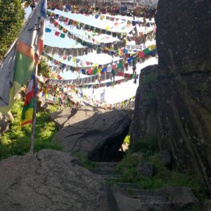 prayer flags hung above carved stairs leading up hill