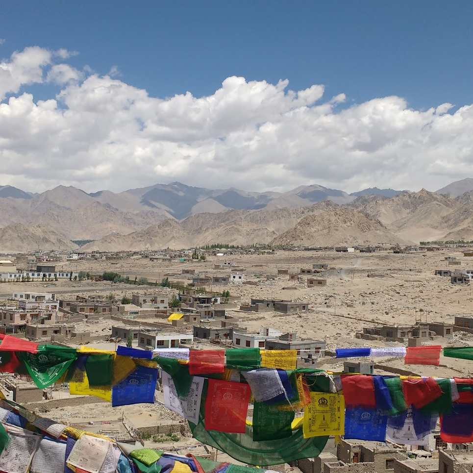 prayer flags and village in arid mountain valley