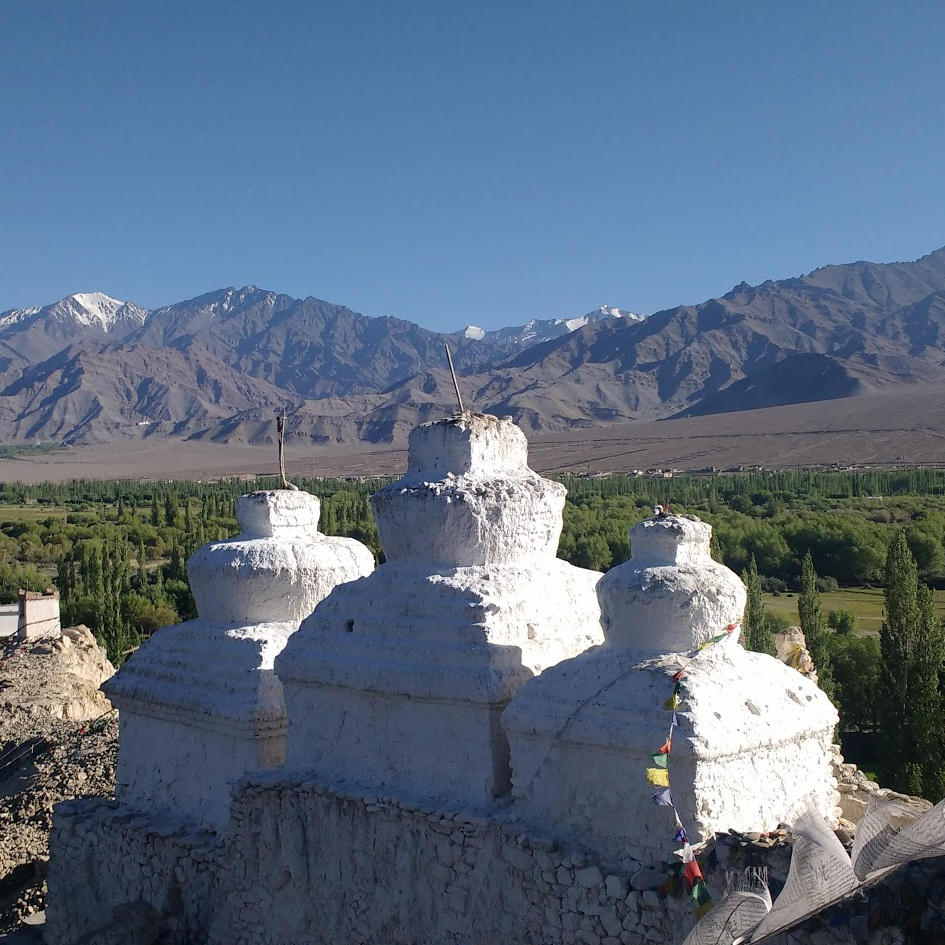 stupas with mountain range in the distance