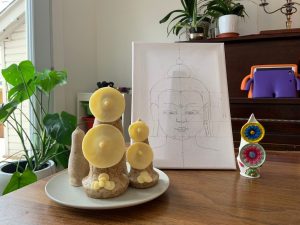 hand-made torma and pencil drawing of the buddha on a table