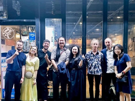 Current and former members of the Ho Centre smiling after a group dinner in Seoul.